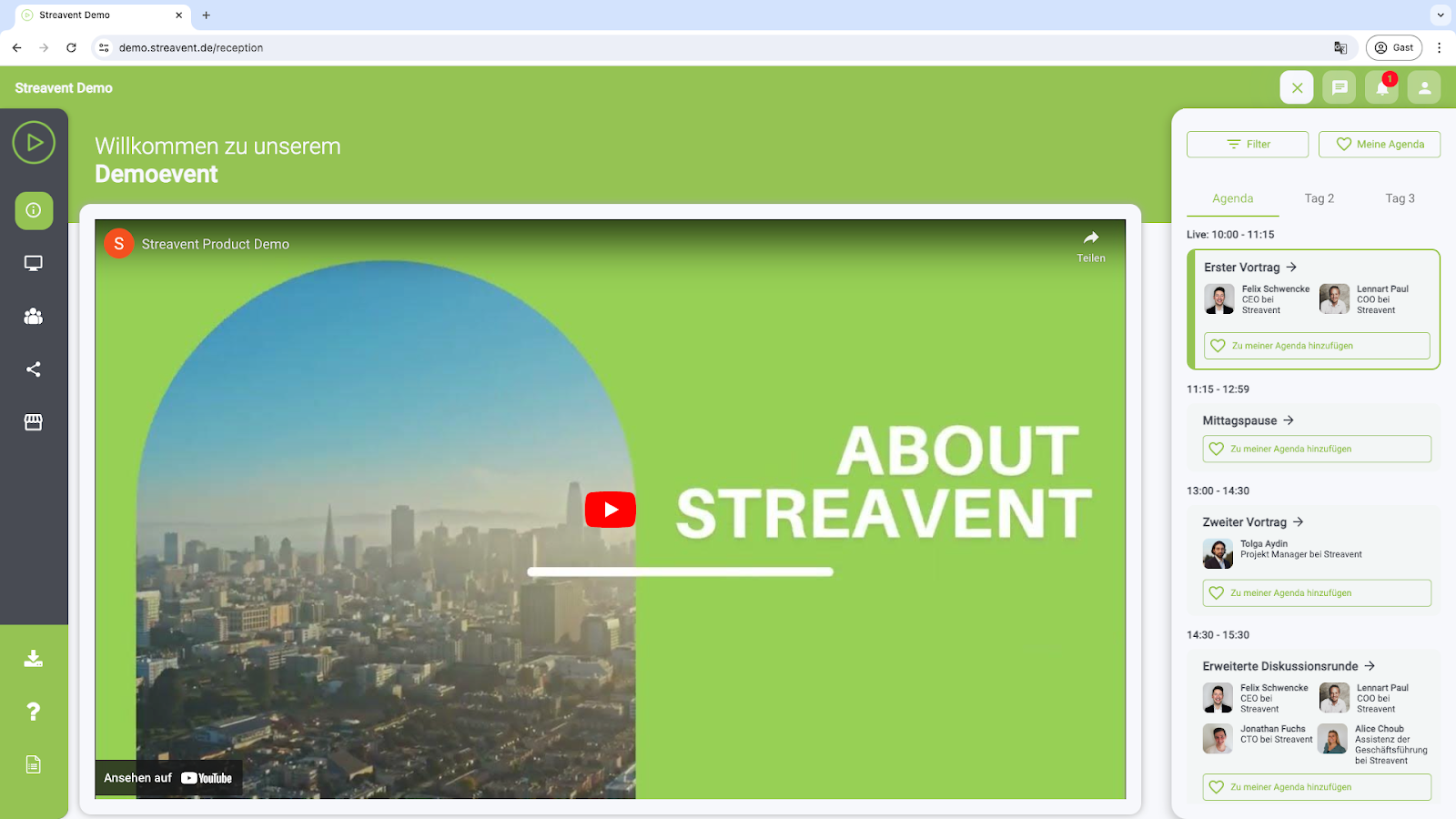 Auf diesem Bild ist der sogenannte Eingangsbereich der digitalen Event Plattform zu sehen. In diesem Bereich werden die Teilnehmer begrüßt und sie können sich einen Überblick über das Event verschaffen. Man sieht ein Video auf der Startseite, sowie eine Navigation der Plattform links und eine Agenda und Netzwerk-Funktion rechts im Bild.